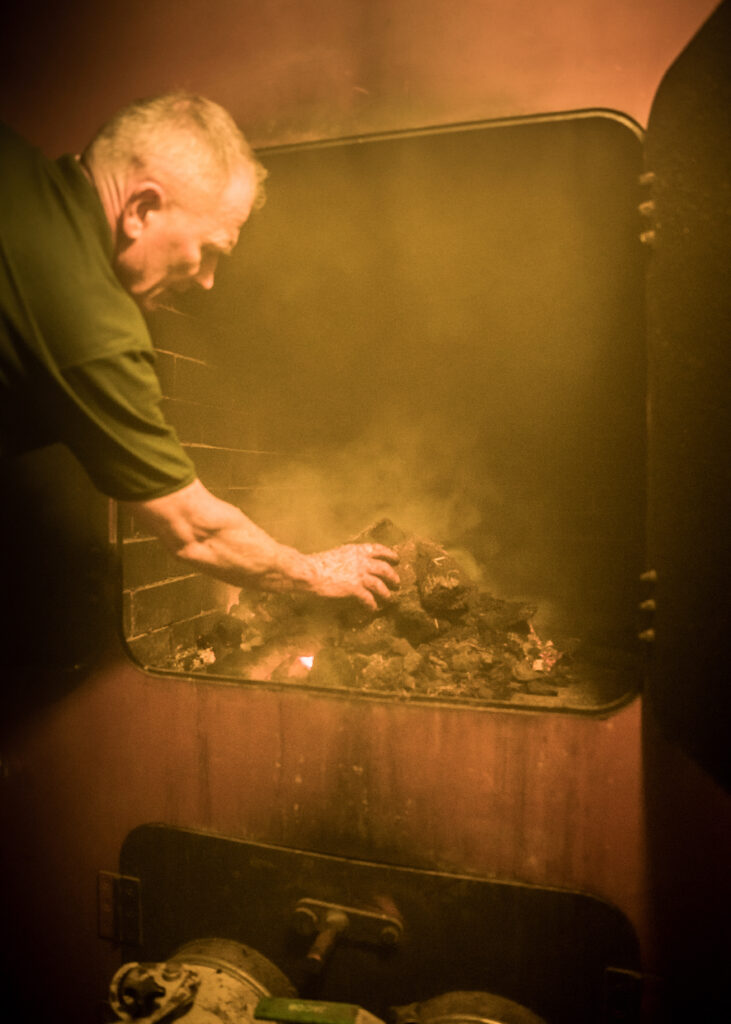 Smoky kiln fire burning peat at the distillery to smoke the barley