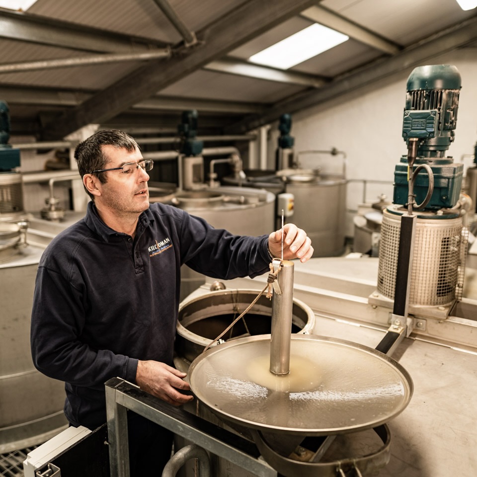 Kevin testing the gravity of the wash after fermentation