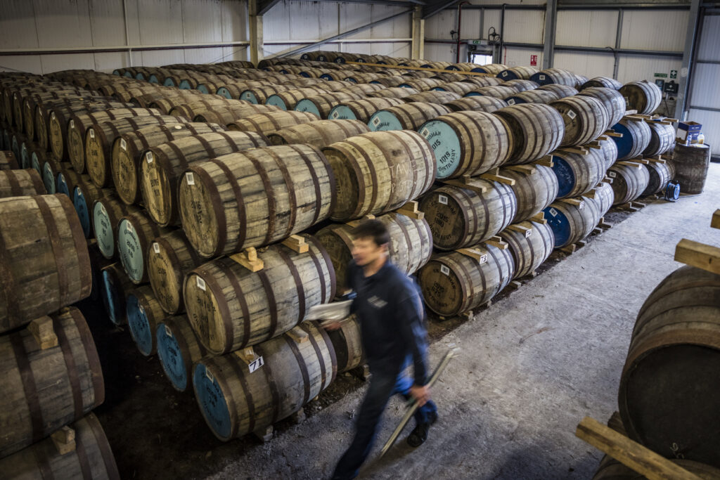 Robin walking through the dunnage warehouse at the distillery