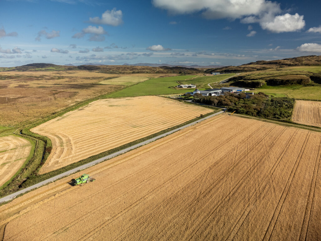 aerial view of barley fields combine harvester and distillery