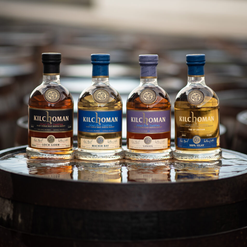 Kilchoman single malt scotch whisky core range bottles on a cask