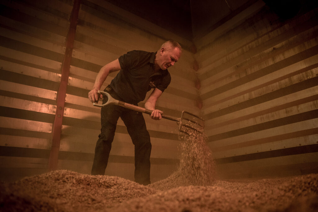 Inside the kiln turning the barley as we smoke the barley inside the kiln 